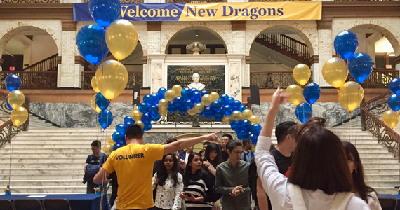 students attending graduate student orientation, blue and gold balloons and welcome sign in the Great Court of Main Building at Drexel